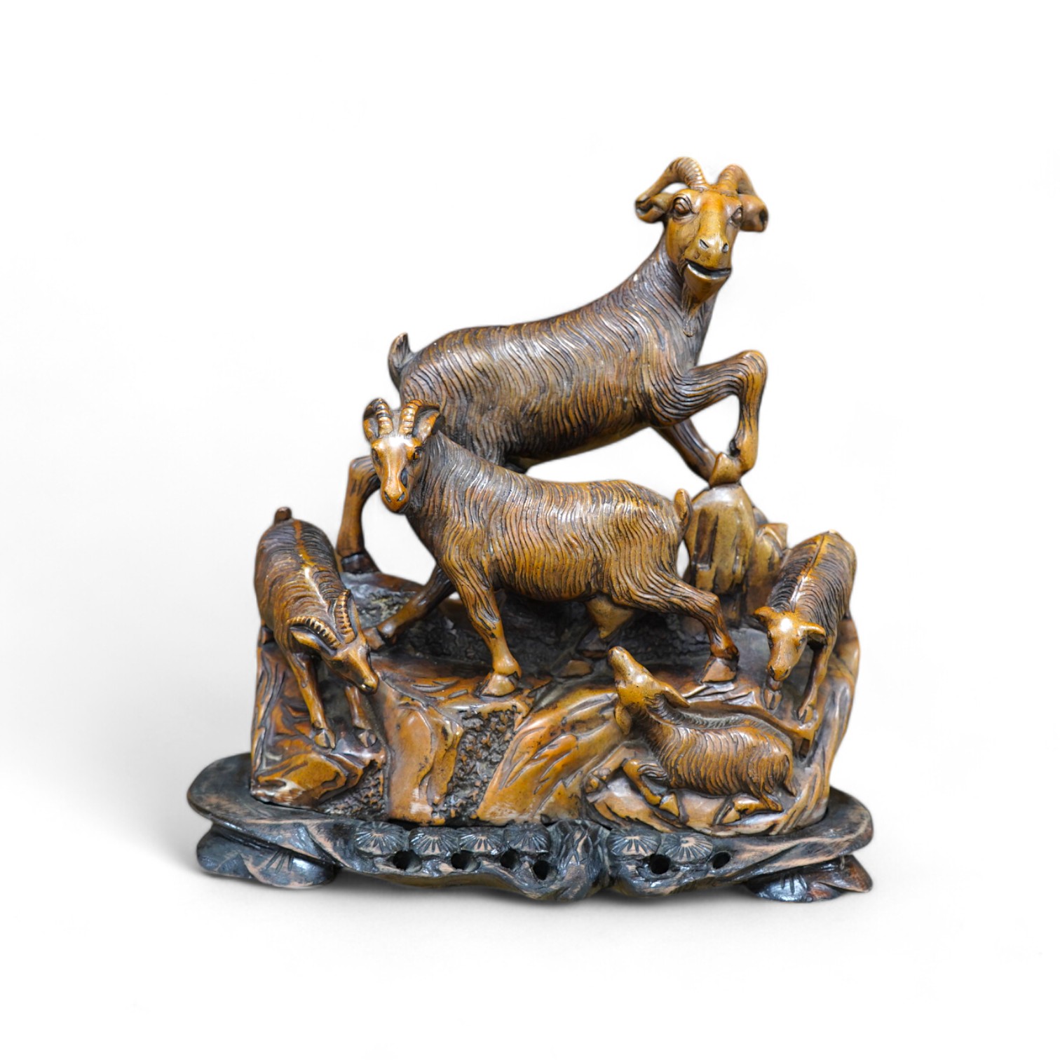 A Chinese carved soapstone figure group of goats on hardwood base, 24cm. Condition - fair to good